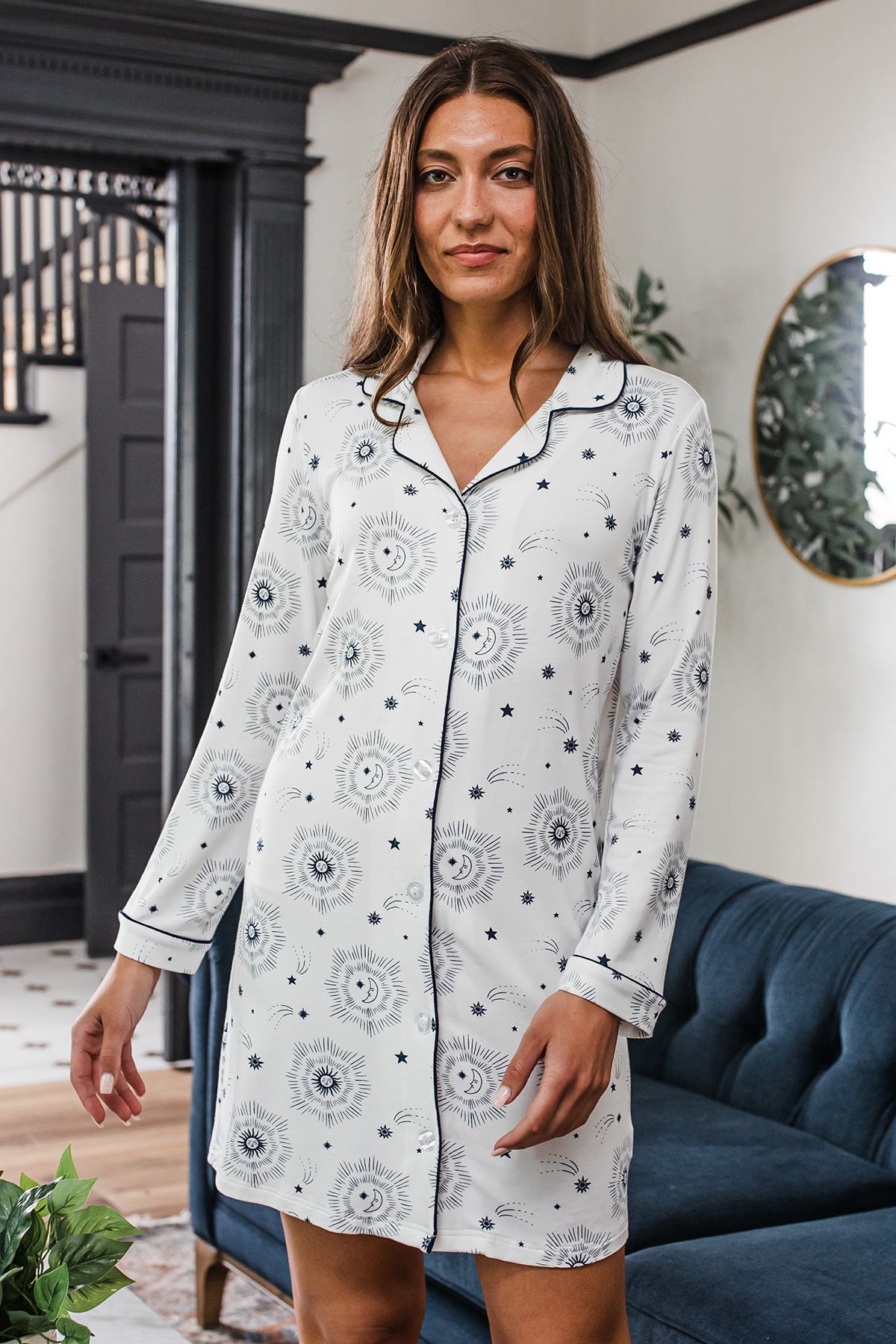 A woman standing while her arms sway, wearing Yala Amber Classic Button Front Bamboo Nightshirt in Celestial Print