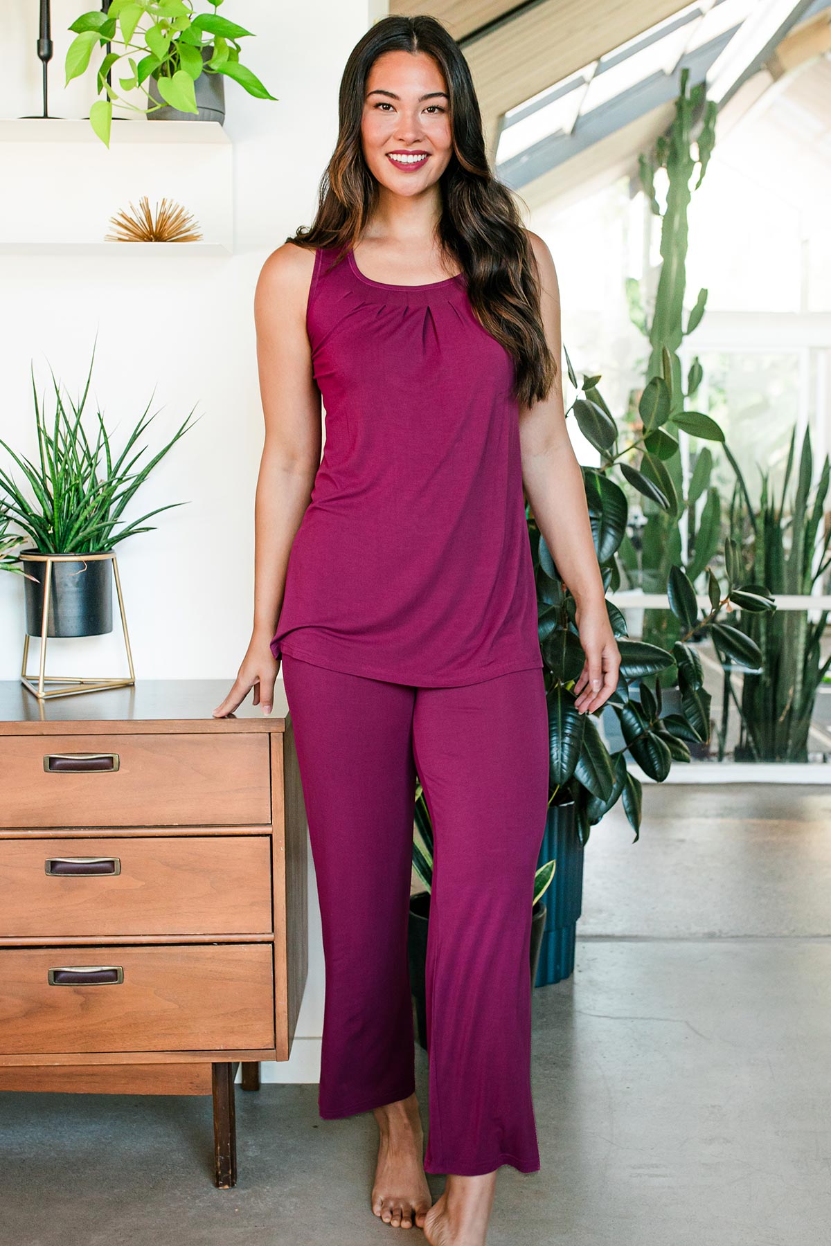 A woman standing and smiling with one leg forward and slightly bent, wearing Yala Delia Gathered Tank Bamboo Pajama Set in Boysenberry