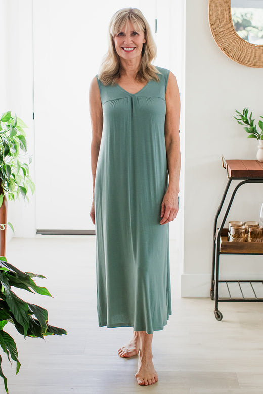 A woman standing wih one foot in front of the other and her hads at her sides, wearing Yala Molly Sleeveless Bamboo Nightgown in Matcha