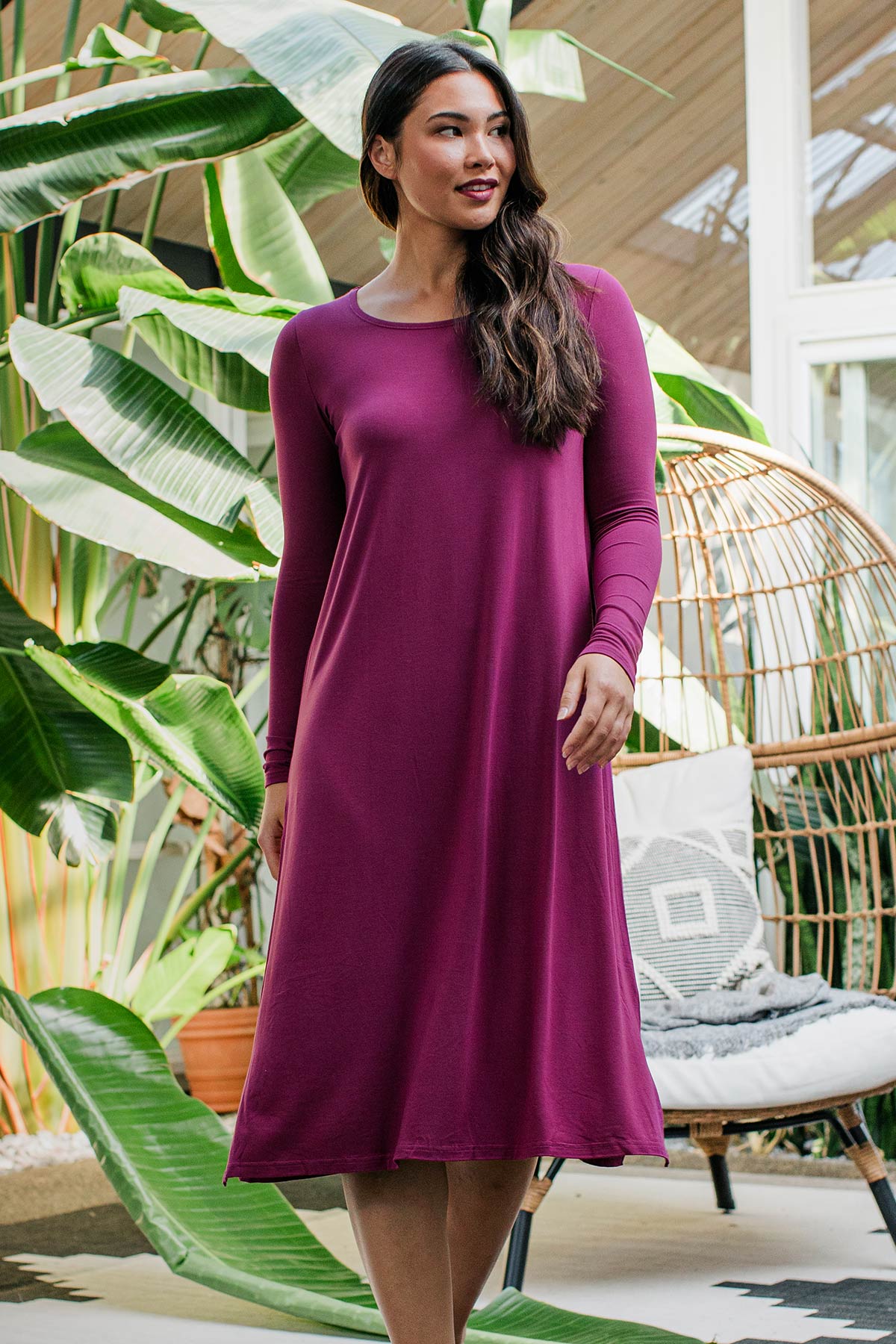 A woman striding forward and glancing off to the side, wearing Yala Neesha Scoop Neck Long Sleeve Bamboo Nightgown in Boysenberry