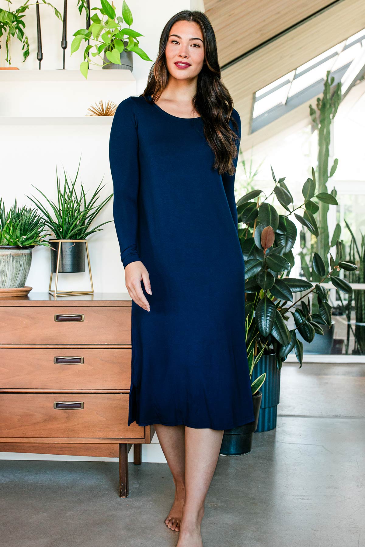 A woman walking forward and looking straight ahead, wearing Neesha Scoop Neck Long Sleeve Bamboo Nightgown in Navy