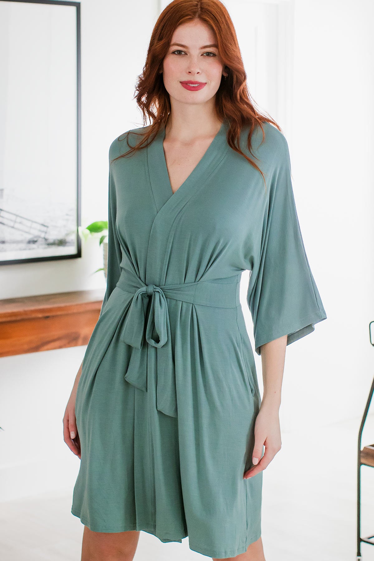A woman standing with her hips tilted and her hands at her sides, wearing Yala Nina Elbow Sleeve Belted Bamboo Robe in Matcha