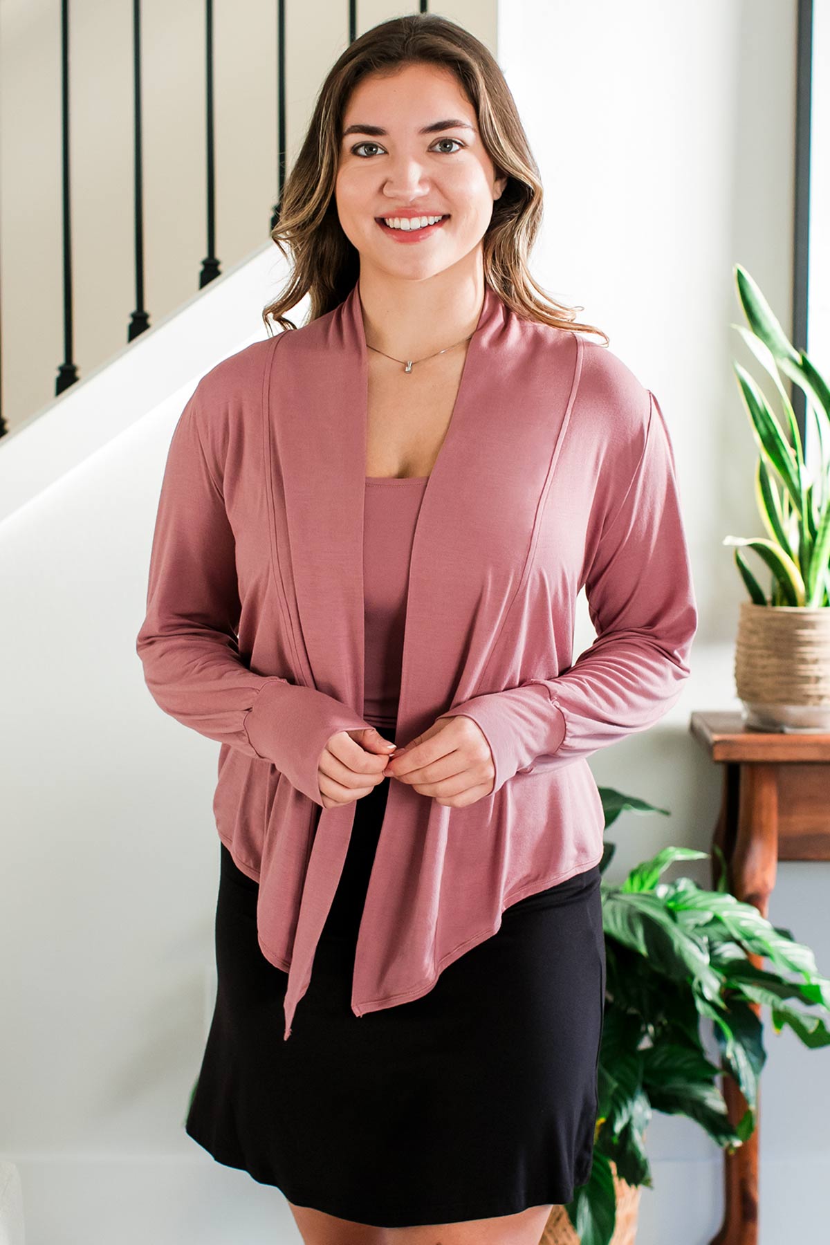 A woman standing and smiling with her hands held in front of her, wearing Yala Everly Puffed Sleeve Bamboo Wrap in Rose