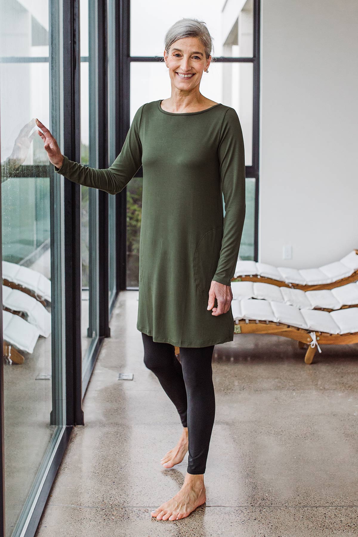 Woman standing and touching a window, wearing Yala Grace Buttersoft™ Bamboo Full Length Leggings in Black