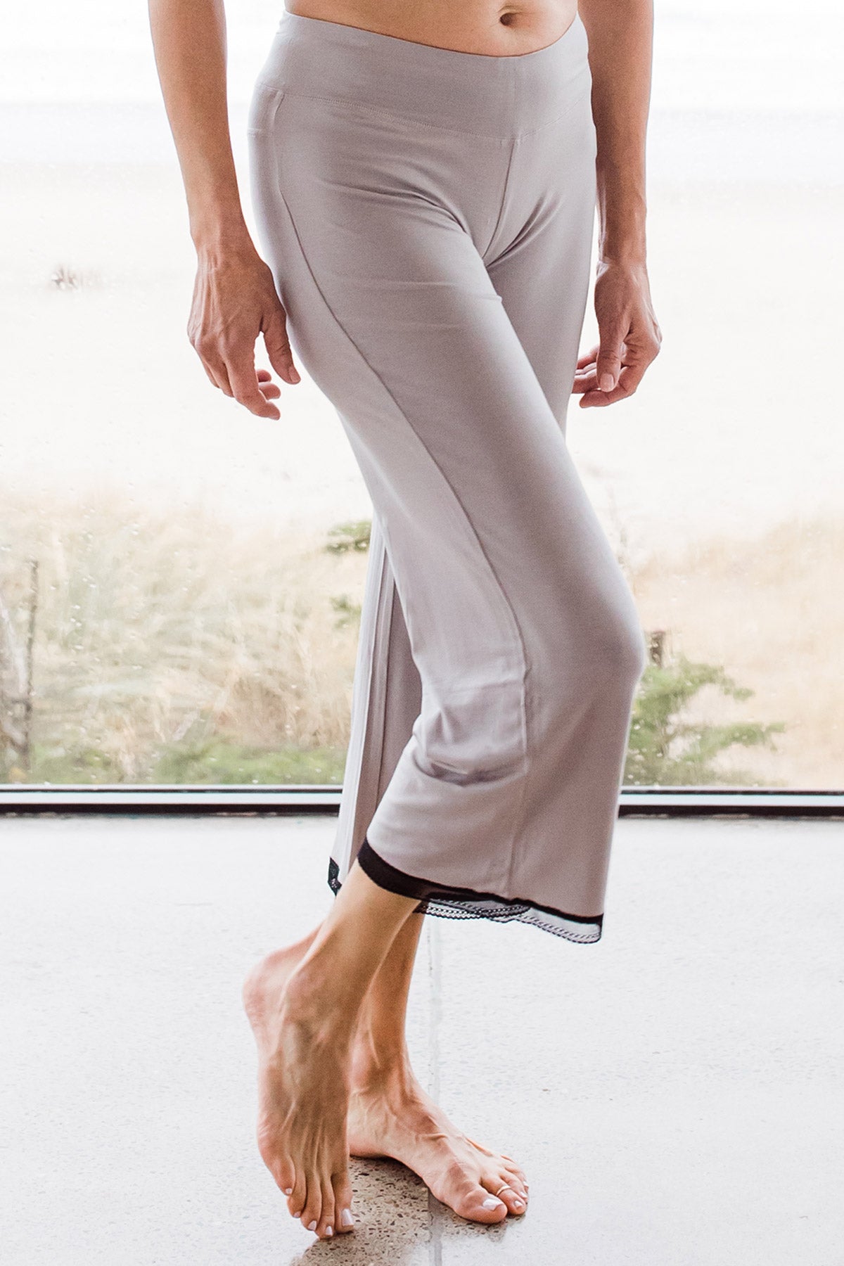 Close shot of a womnan's legs, wearing Yala Iris Lace Bamboo Pajama Set in Ash