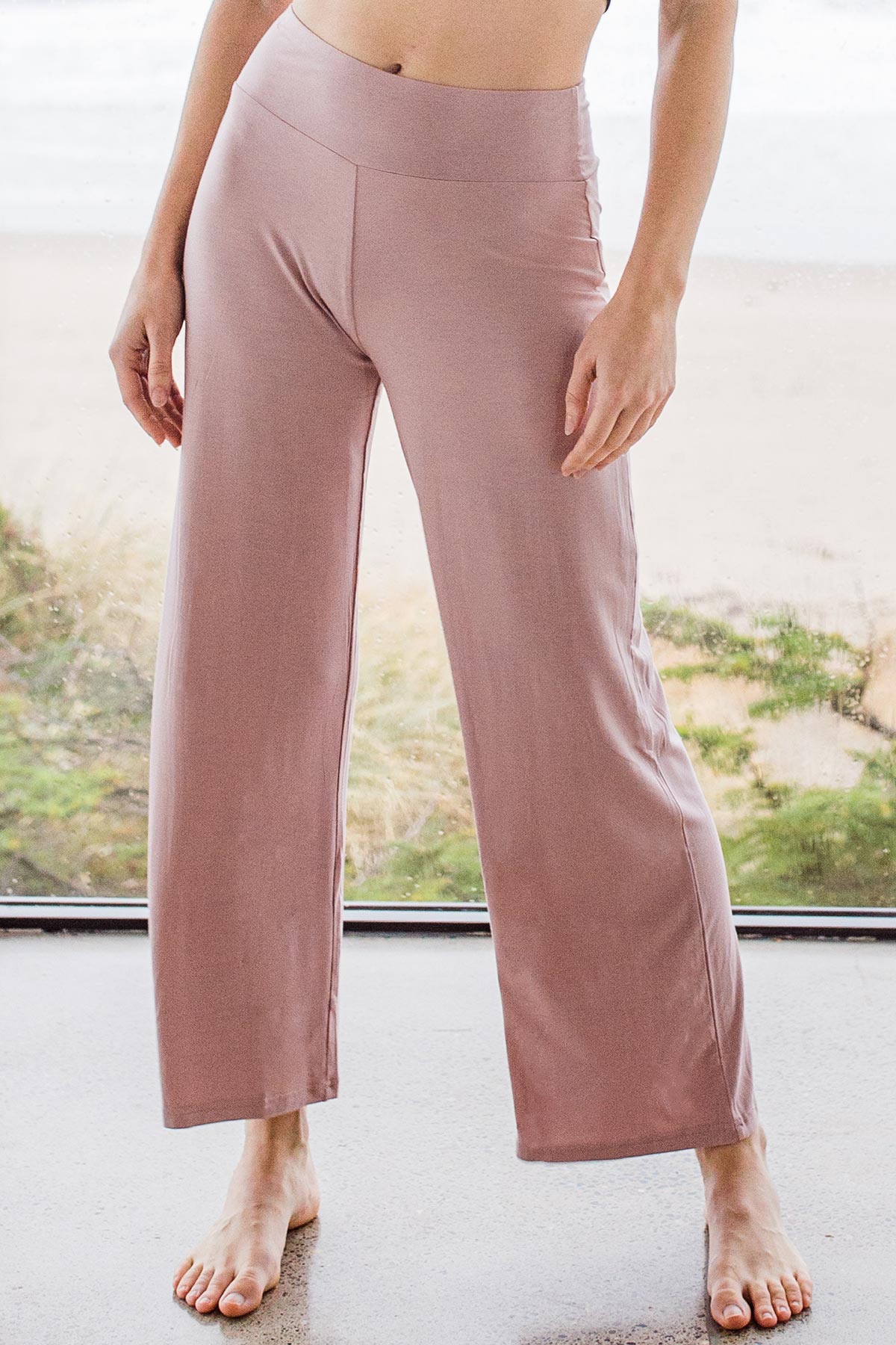 Close shot of a woman's legs, wearing Yala Kat Lounge Bamboo Pajama Set in Lotus Pink