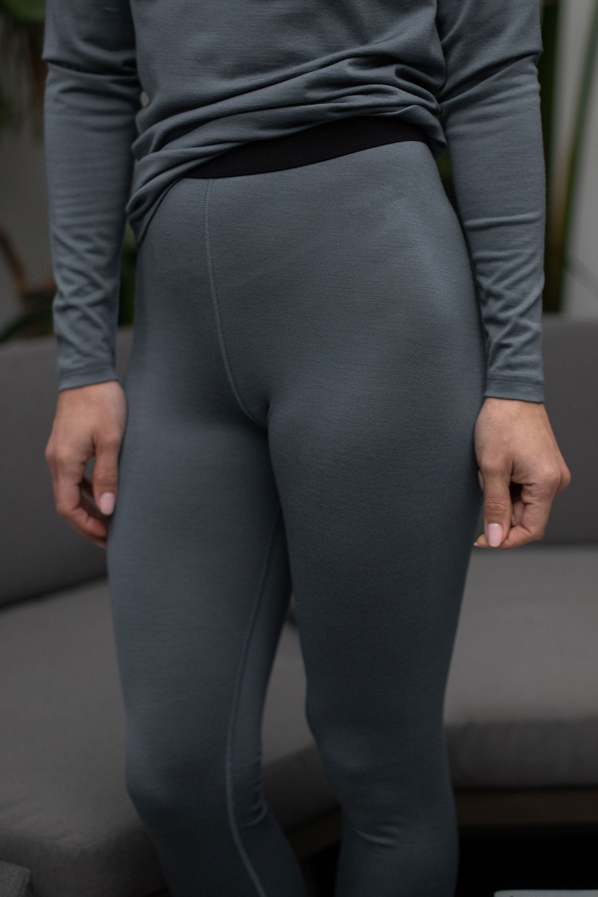 Close shot of a woman's legs, wearing Yala Superfine Merino Wool Leggings in Storm Grey