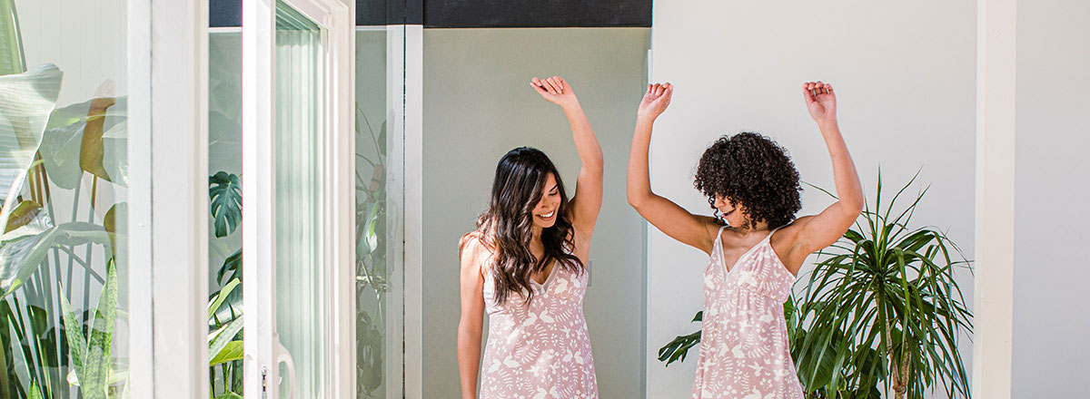 Two Friends Dancing in Matching Pink YALA Pajamas