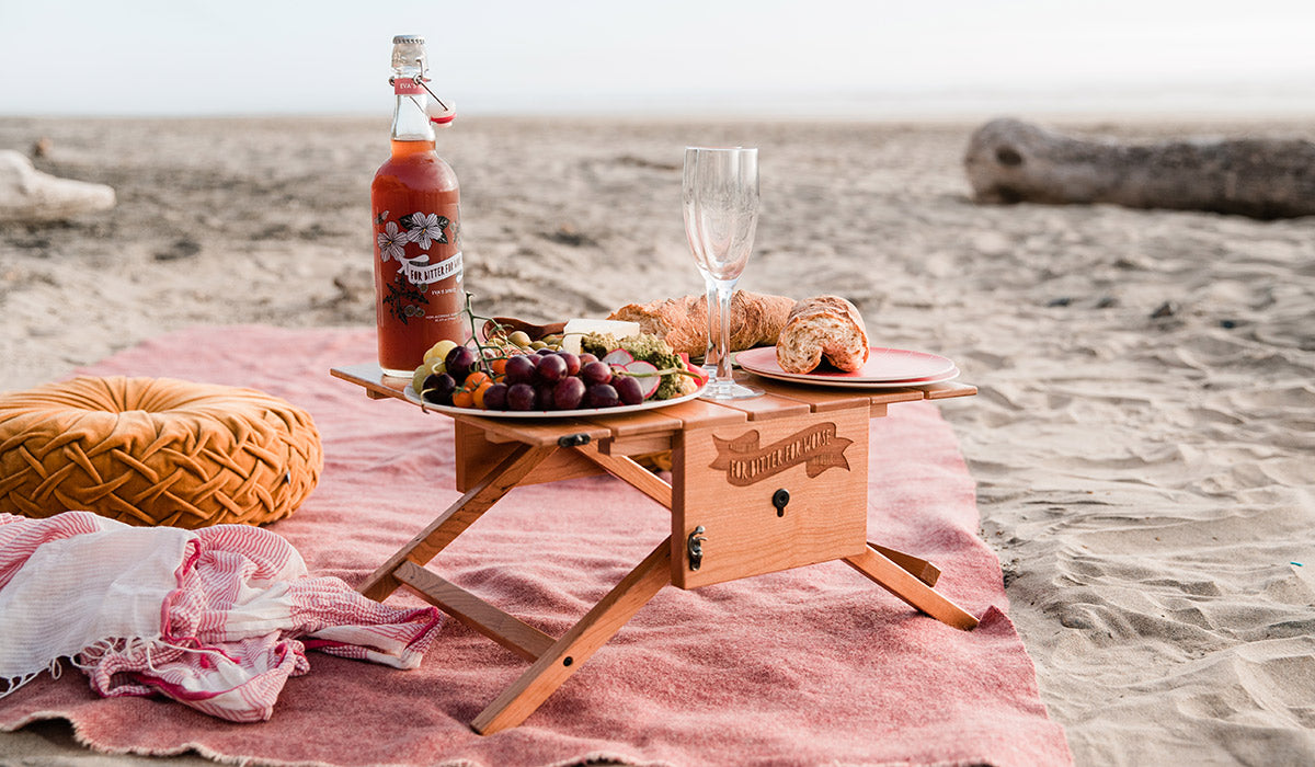 Picnic on the Beach with charcuterie board and For Bitter For Worse beverages. 