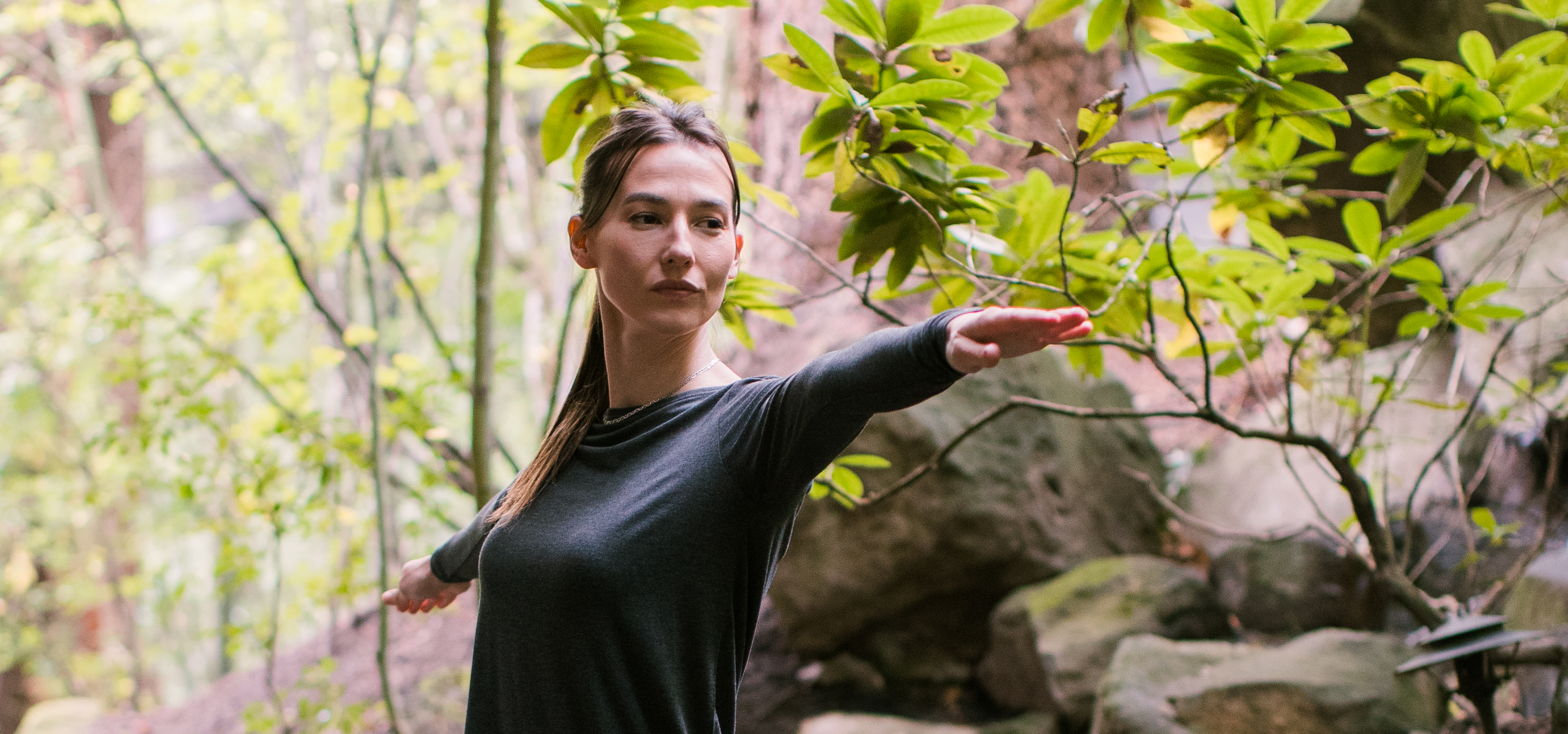 Woman doing yoga standing in warrior pose wearing YALA leggings.