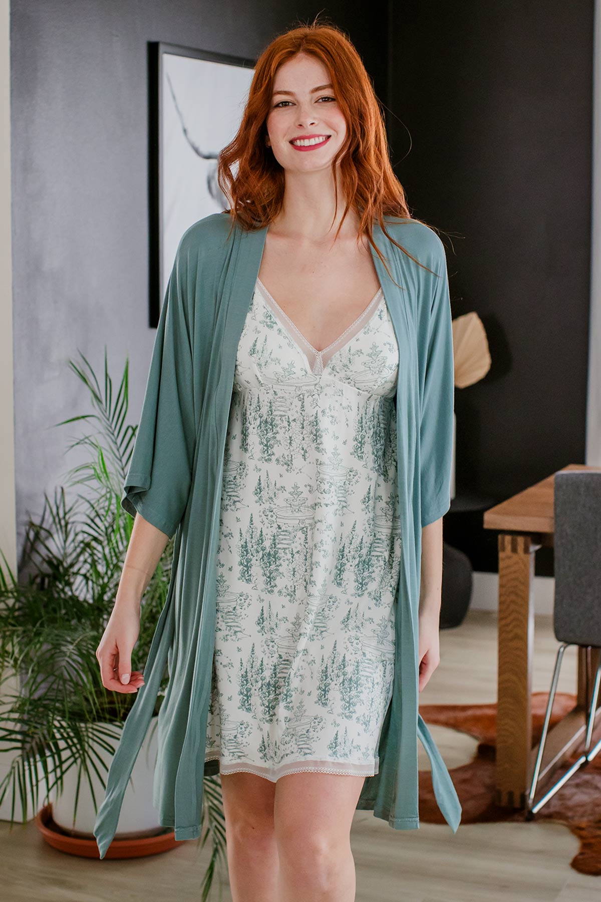 A woman walking towards the camera and smiling, wearing Yala Irish Lace Bamboo Nightgown in English Garden Print