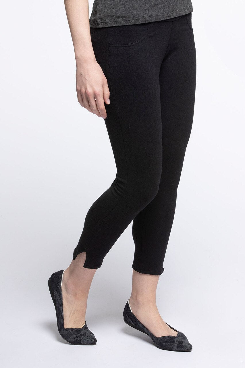 Close shot of a woman's legs and hips standing with one knee bent, wearing Yala Audrey Cropped Bamboo and Organic Cotton Pencil Pants in Black