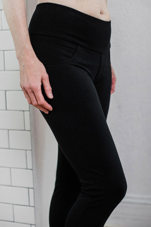Close shot of a woman's hips and legs, wearing Yala Beckett High-Waisted Bamboo and Organic Cotton Skinny Pants in Black