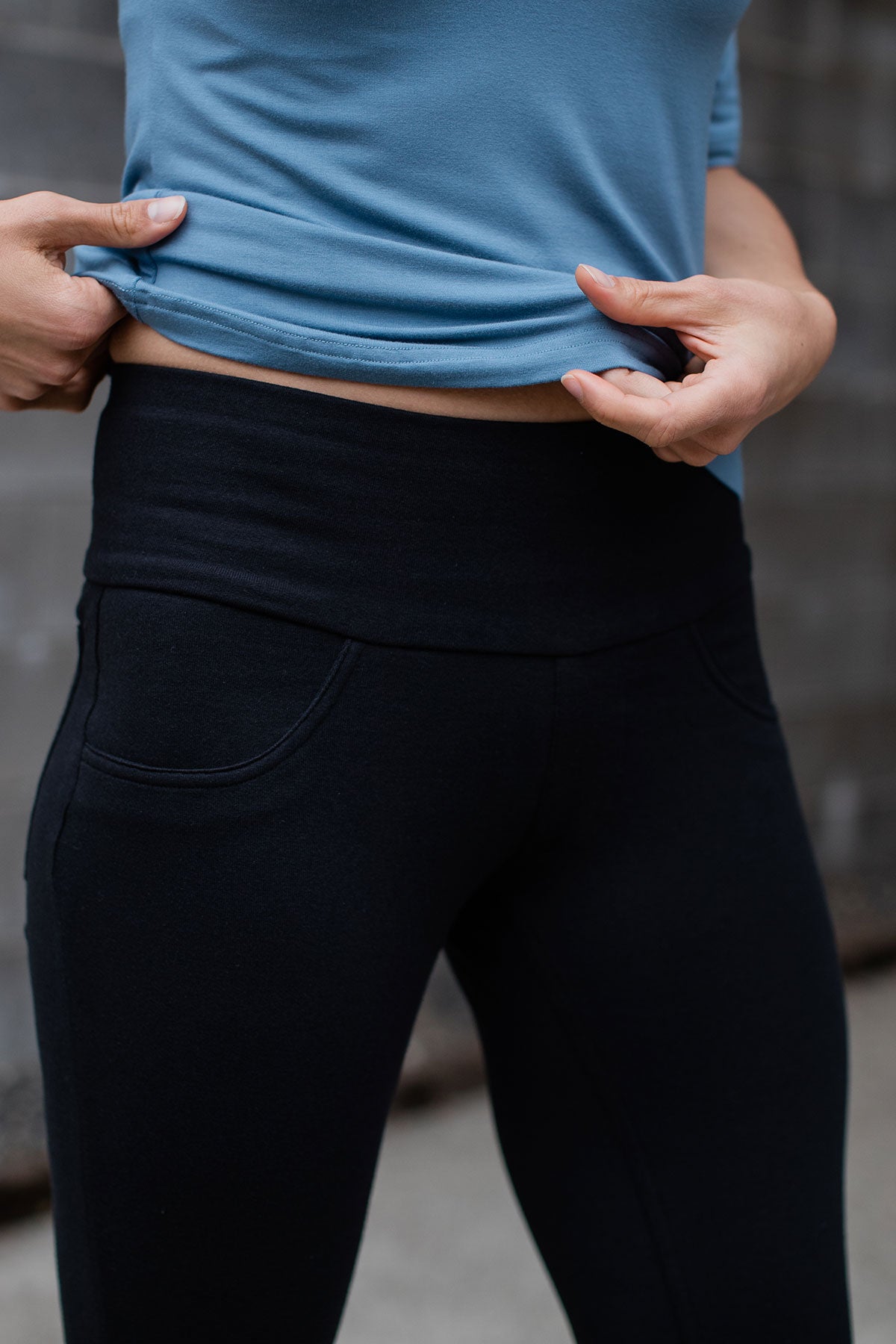 Close shot of a woman's hips and thighs, wearing Yala Beckett High-Waisted Bamboo and Organic Cotton Skinny Pants in black