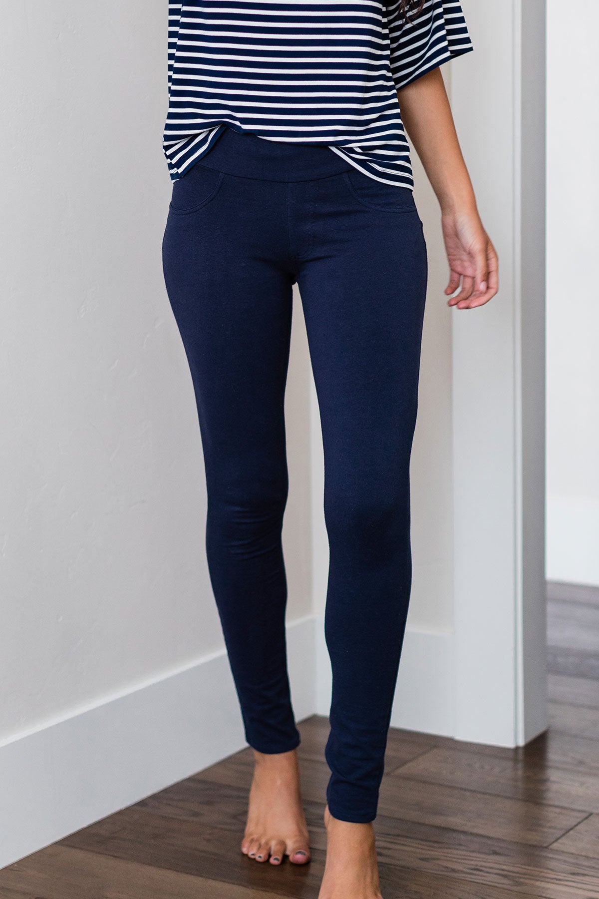 Close shot of a woman's hips and legs, wearing Yala Blake Tailored Bamboo and Organic Cotton Skinny Pants in Navy