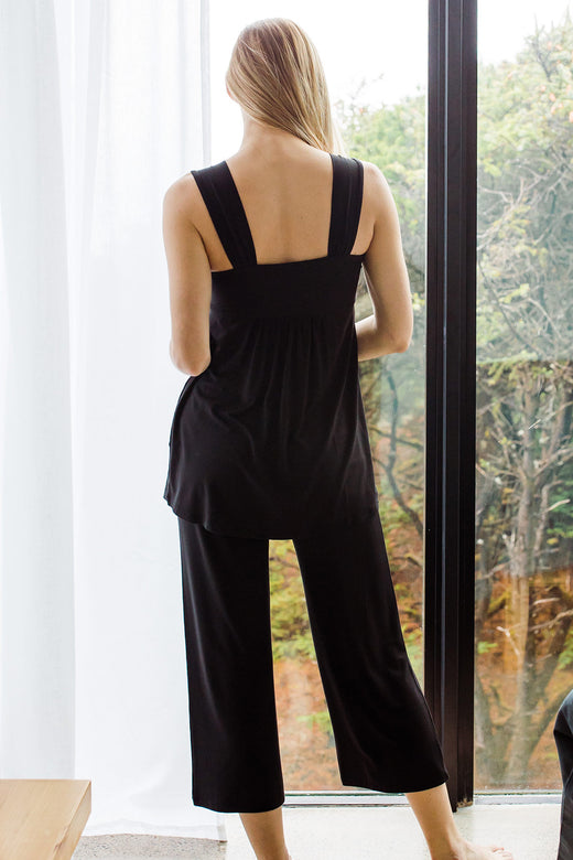Woman standing with her back turned, wearing Yala Cleo Babydoll Bamboo Pajama Set in Black
