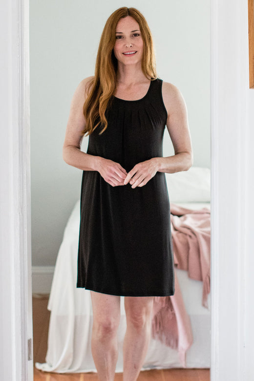 A woman standing with both hands in front of her, wearing Yala Delia Gathered Tank Bamboo Nightgown in Black