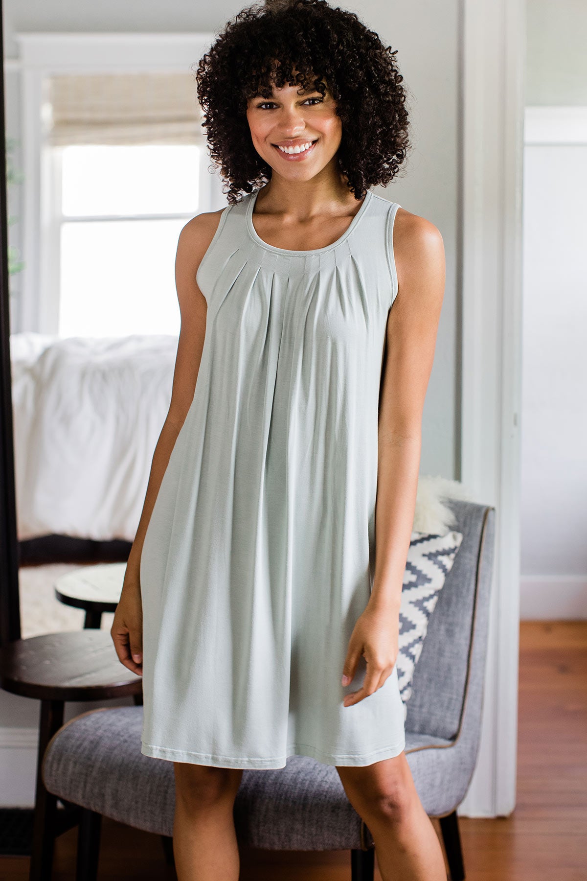 A woman standing and smiling with both hands at her sides, wearing Yala Delia Gathered Tank Bamboo Nightgown in Honeydew
