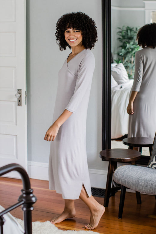 A woman walking to the side and turning her head to smile at the camera, wearing Yala Haley Crossover Front Three Quarter Sleeve Bamboo Nightgown in Ash