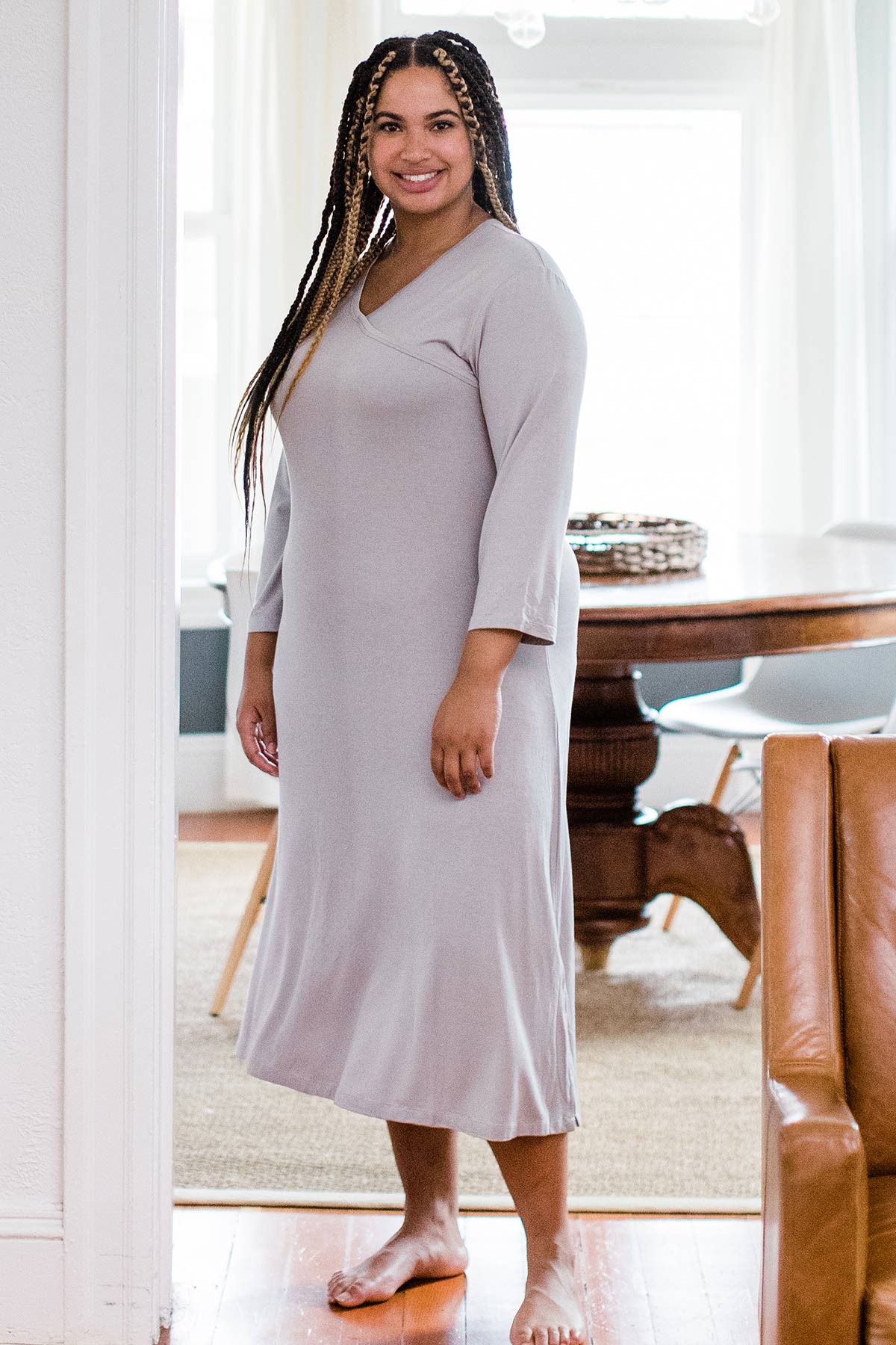 A woman standing slightly sideways and smiling at the camera, wearing Yala Haley Crossover Front Three Quarter Sleeve Bamboo Nightgown in Ash