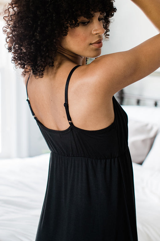 Close shot of a woman's head and torso with her arms raised, wearing Yala Iris Lace Bamboo Nightgown in Black