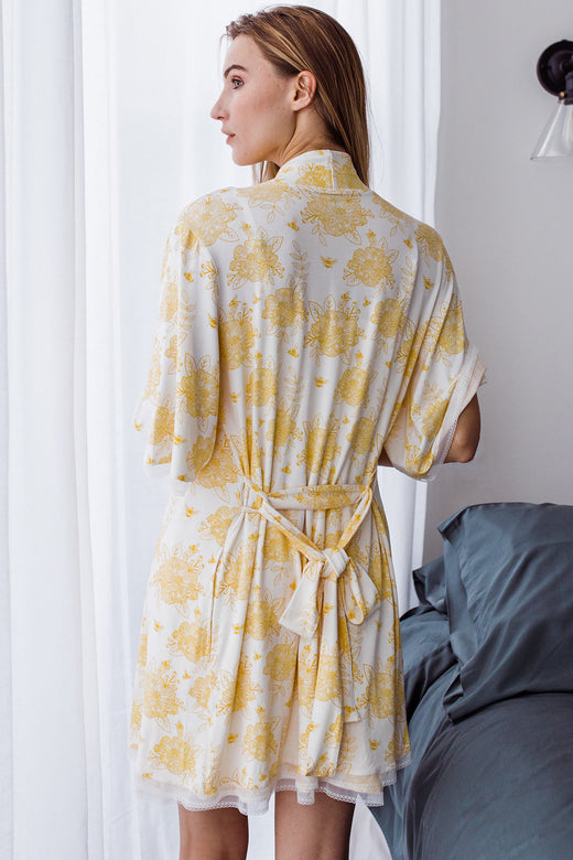 Woman standing with her back turned, wearing Yala Iris Lace Bamboo Robe in Honeybee