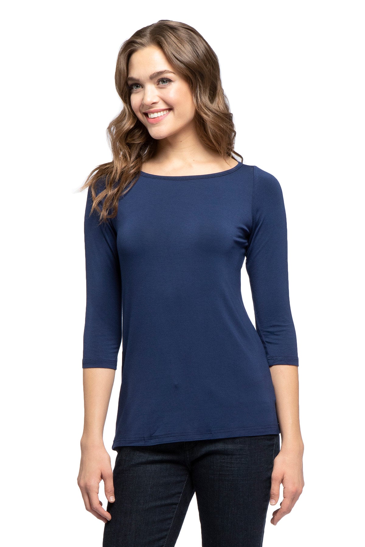 A woman standing and smiling with both hands at her sides, wearing Yala Kai Boatneck Three Quarter Sleeve Relaxed Fit Bamboo Tee Shirt in Navy