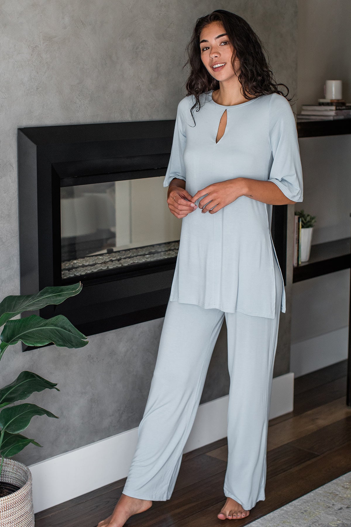 A woman standing with one foot forward, wearing Yala Kat Lounge Bamboo Pajama Set in Sky