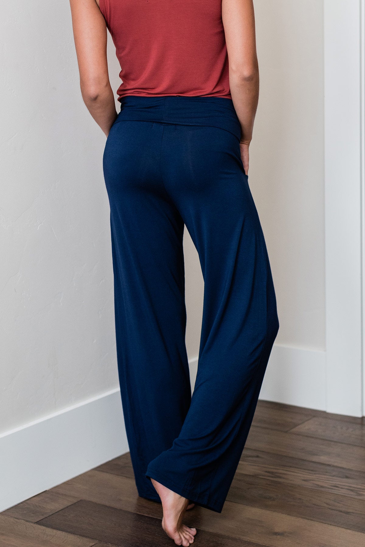 Close shot of a woman's legs from behind, wearing Yala Kayla Wide Leg Foldover Waist Bamboo Pants in Navy