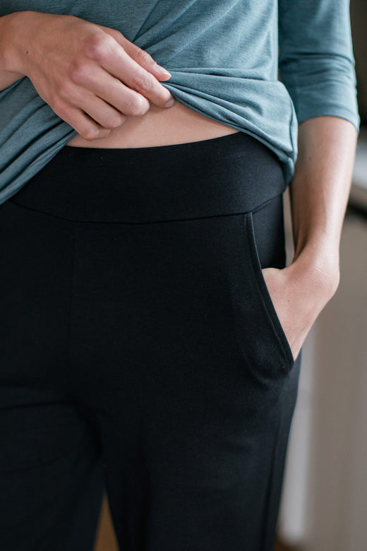 Close shot of a woman's hips, wearing Yala Lexi Ultra-Stretch Bamboo and Organic Cotton Classic Wide Leg Pants in Black