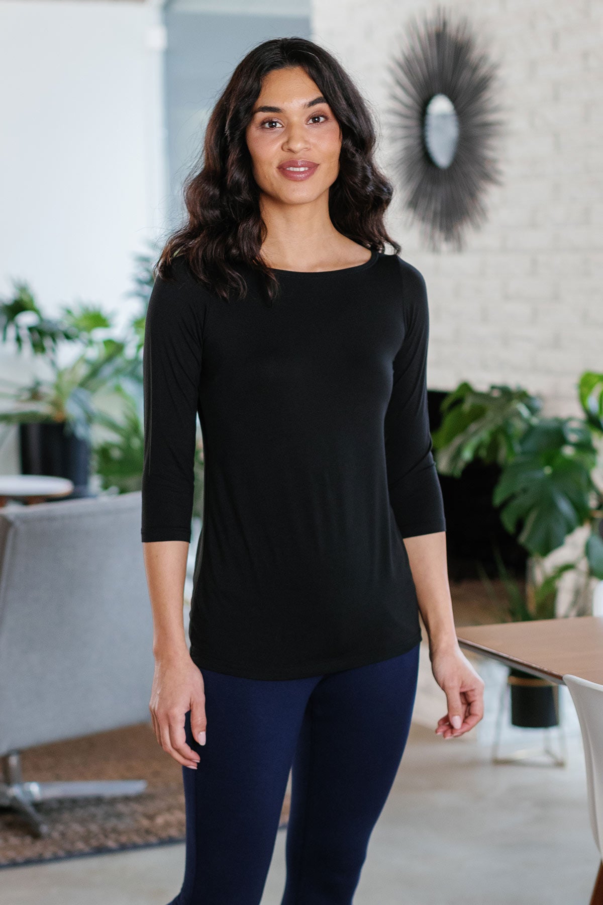 A woman standing with both hnds at her sides, wearing Yala Kai Boatneck Three Quarter Sleeve Relaxed Fit Bamboo Tee Shirt in Black
