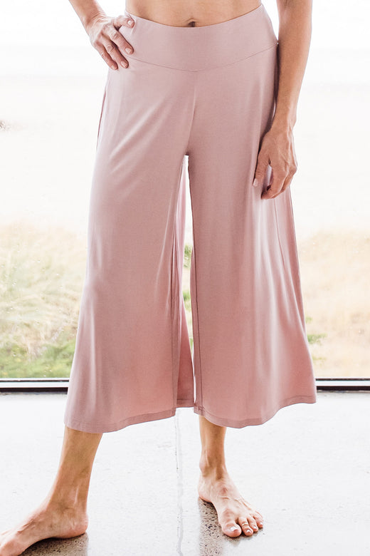Close shot of a woman's legs, wearing Yala Opal Swing Lounge Bamboo Pajama Set in Lotus Pink