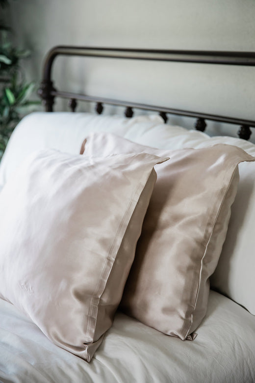 A pair of pillows enshrouded in Yala Charmeuse Pillowcase Set in Moonstone