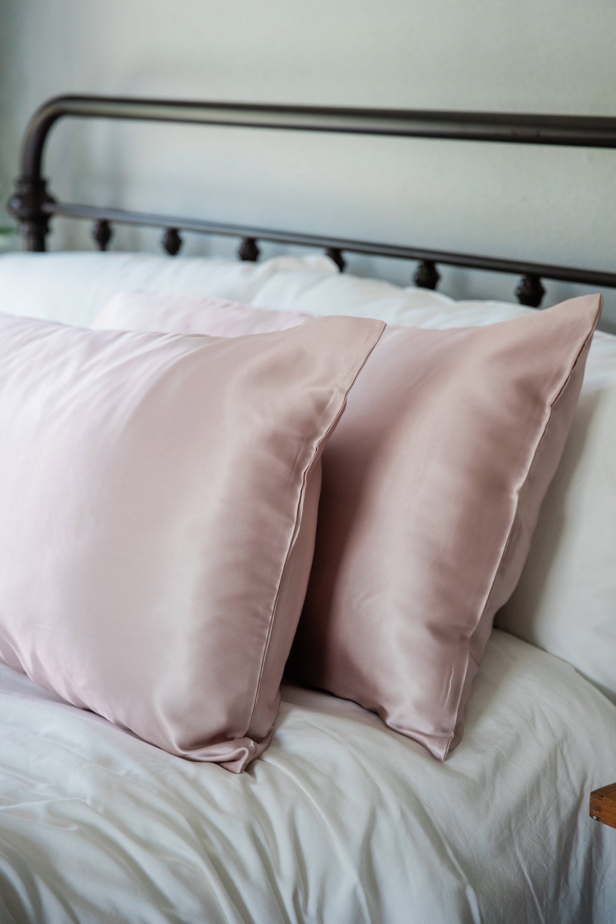A pair of pillows enshrouded in Yala Charmeuse Pillowcase Set in Rose Quartz